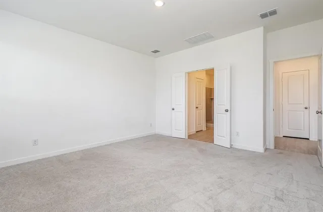 a large kitchen with stainless steel appliances granite countertop a large counter top and a wooden floors