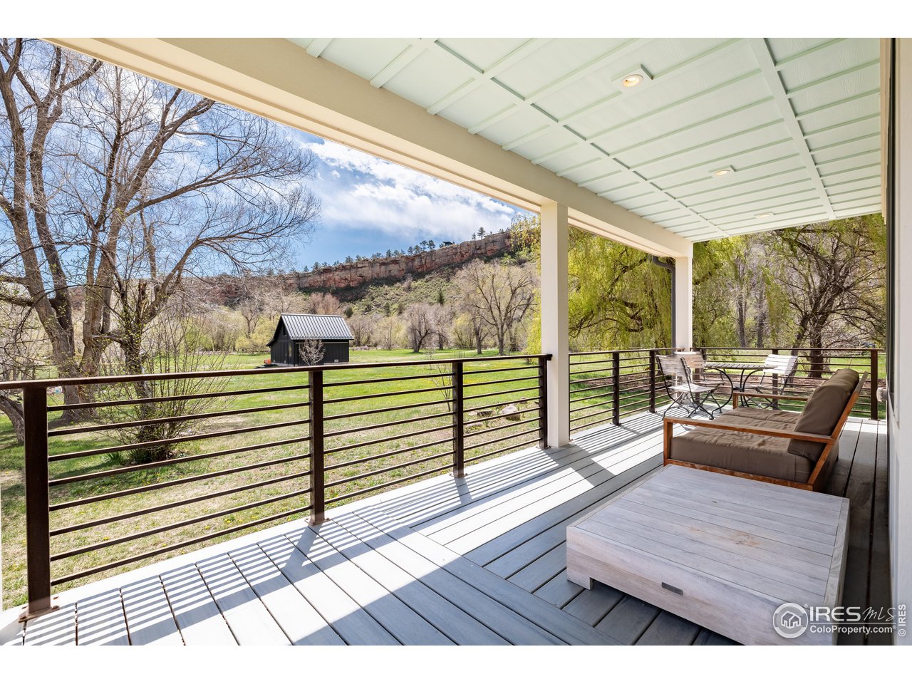 354 Apple Valley Road Lyons, CO 80540 - Photo 19 of 40 a view of a balcony with wooden floor and furniture