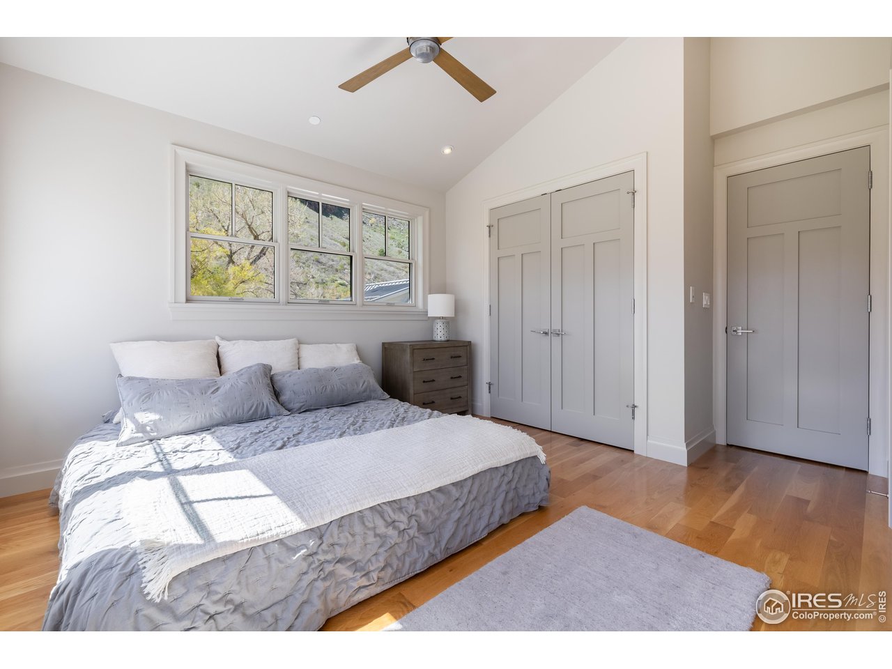 354 Apple Valley Road Lyons, CO 80540 - Photo 21 of 40 a bedroom with a bed and a night stand