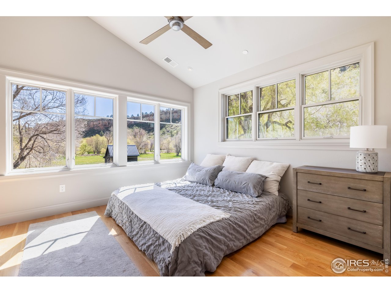354 Apple Valley Road Lyons, CO 80540 - Photo 22 of 40 a bedroom with a bed mirror and window