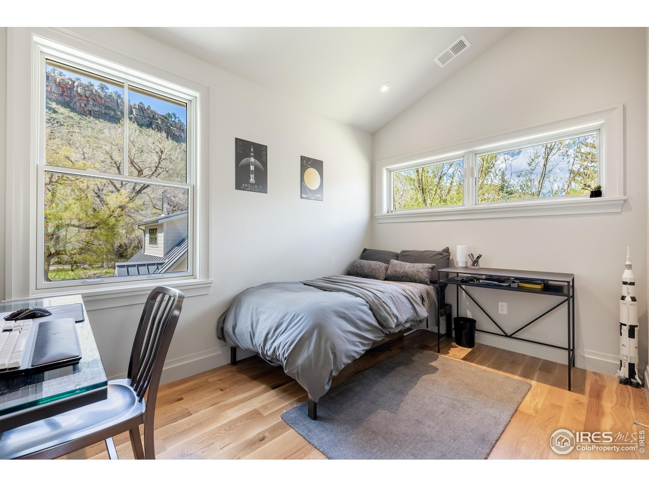 354 Apple Valley Road Lyons, CO 80540 - Photo 26 of 40 a bedroom with a bed and wooden floor