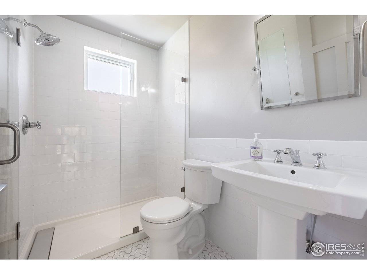 354 Apple Valley Road Lyons, CO 80540 - Photo 28 of 40 a bathroom with a sink a toilet and shower