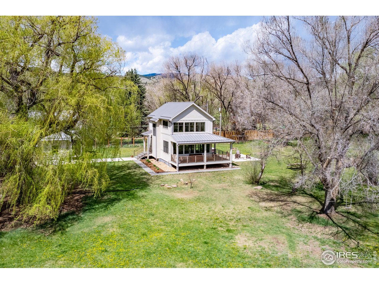 354 Apple Valley Road Lyons, CO 80540 - Photo 34 of 40 a view of a house with a big yard with large trees