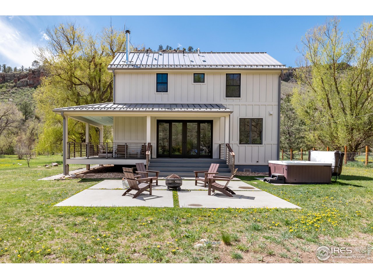 354 Apple Valley Road Lyons, CO 80540 - Photo 6 of 40 a view of a patio with table and chairs under an umbrella