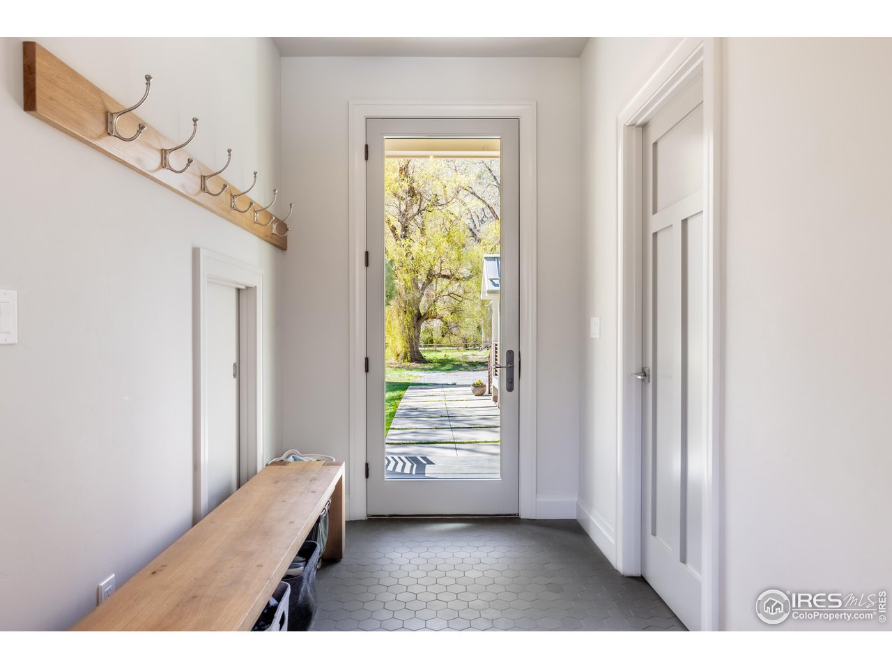 354 Apple Valley Road Lyons, CO 80540 - Photo 7 of 40 a view of a bedroom with wooden floor and windows