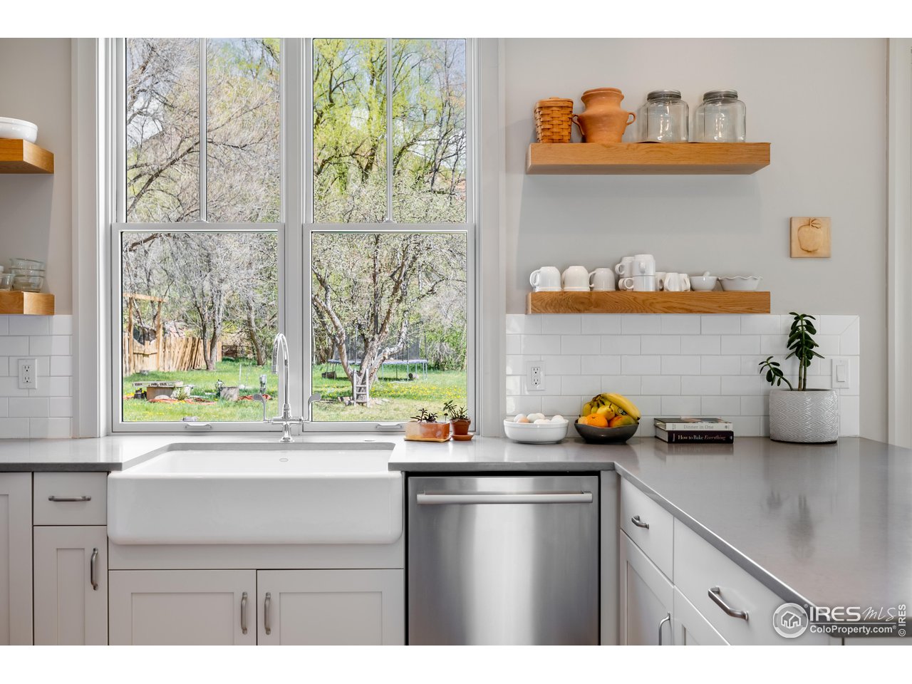 354 Apple Valley Road Lyons, CO 80540 - Photo 8 of 40 a kitchen with a window a sink and wooden cabinets