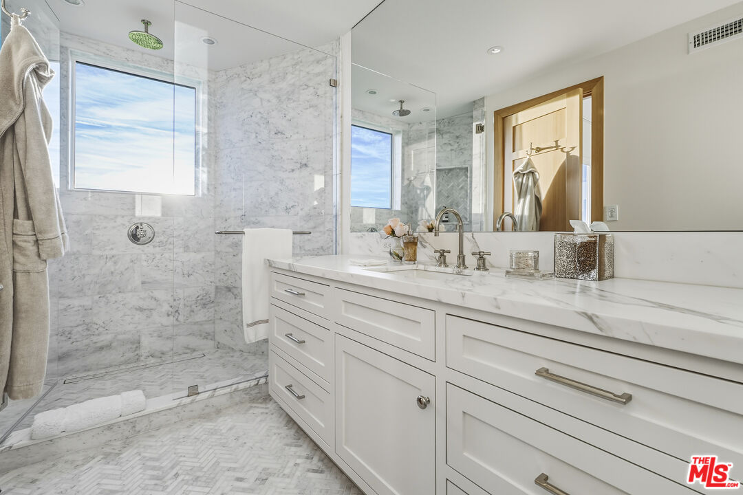 3140 Sweetwater Mesa Road Malibu, CA 90265 - Photo 31 of 71 a bathroom with a shower sink and mirror