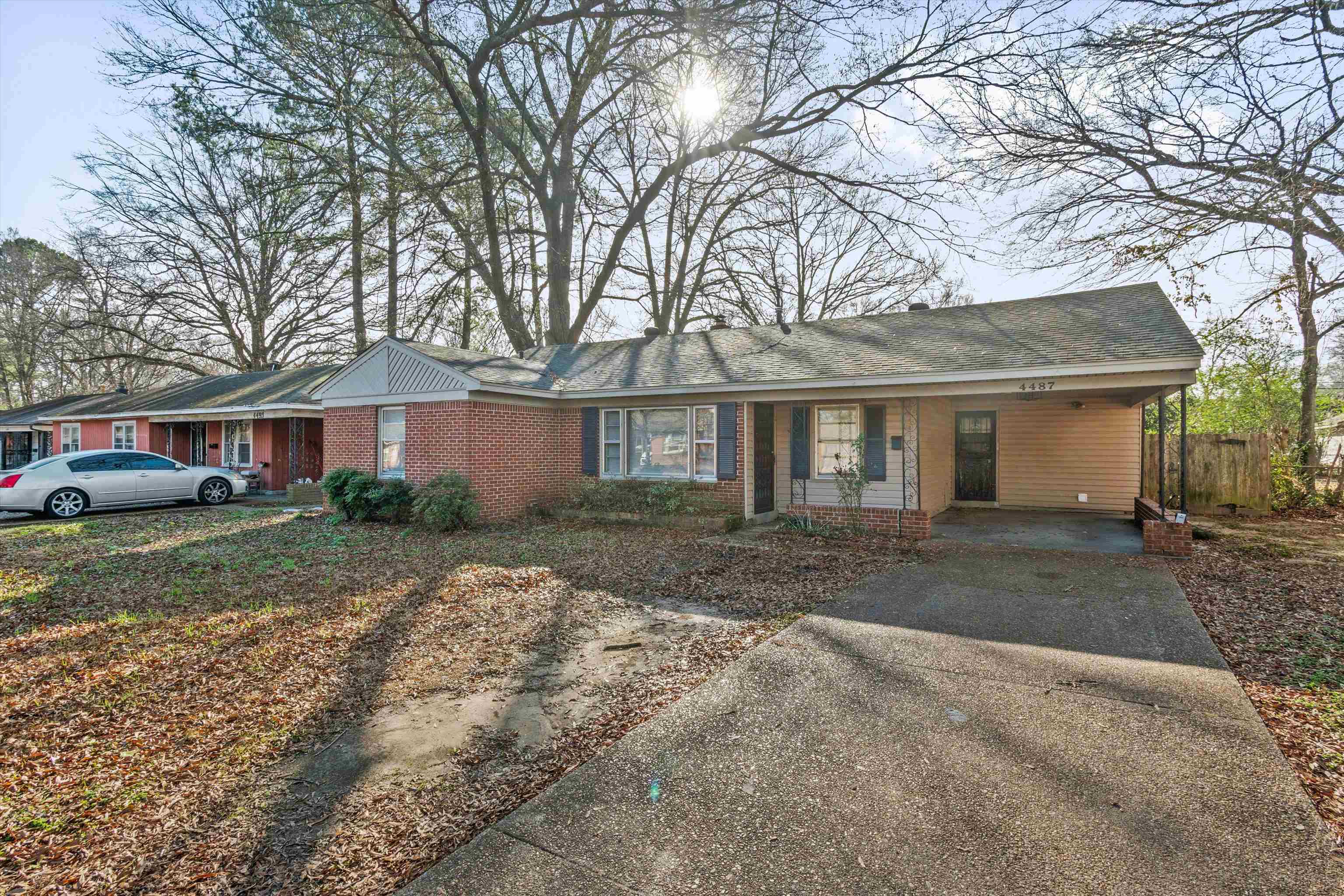 4487 East Dearing Road Memphis, TN 38117 - Photo 2 of 27 Ranch-style home with an attached carport, driveway, brick siding, a porch, and a shingled roof