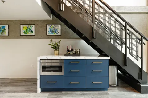 a kitchen with stainless steel appliances kitchen island granite countertop a sink and cabinets