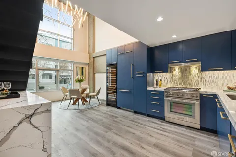 a kitchen with stainless steel appliances granite countertop a stove and cabinets