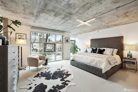 a bedroom with a large bed and a chandelier