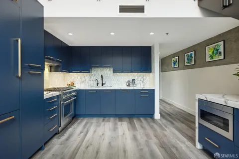 a kitchen with stainless steel appliances granite countertop a stove and a sink