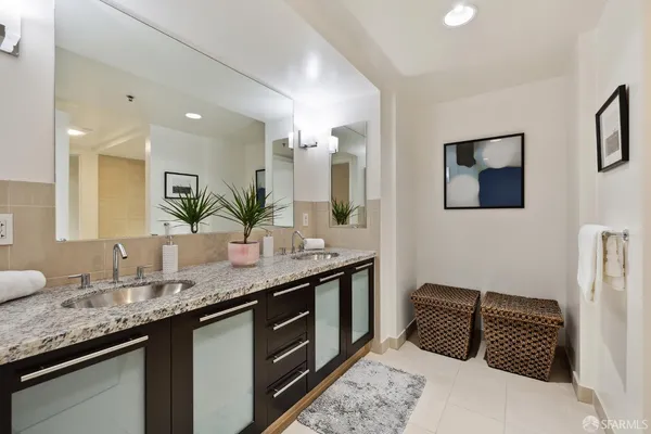 a bathroom with a granite countertop sink and a mirror