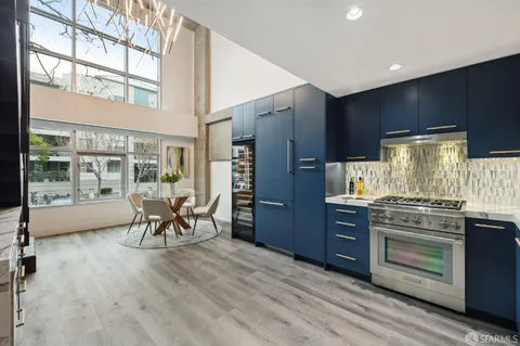 a kitchen with stainless steel appliances granite countertop a stove and cabinets