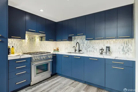 a kitchen with granite countertop wooden cabinets and white appliances