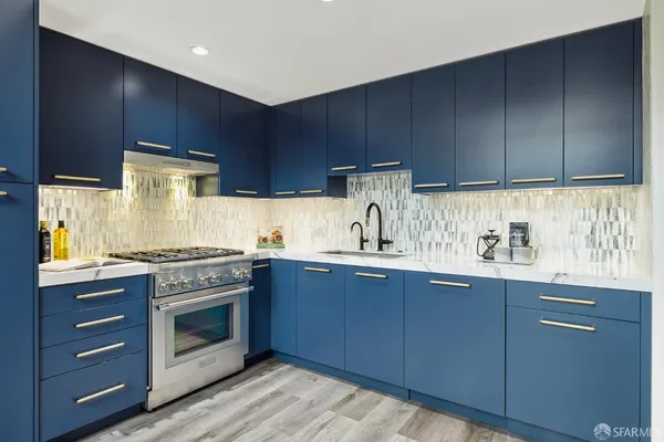 a kitchen with granite countertop wooden cabinets and white appliances