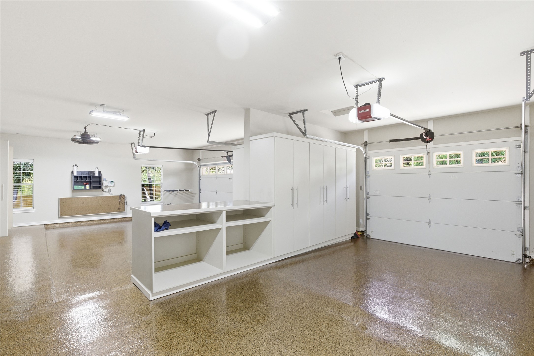 1204 Orlando Road Austin, TX 78733 - Photo 14 of 40 A well-organized garage offers ample storage and a pristine epoxy floor.
