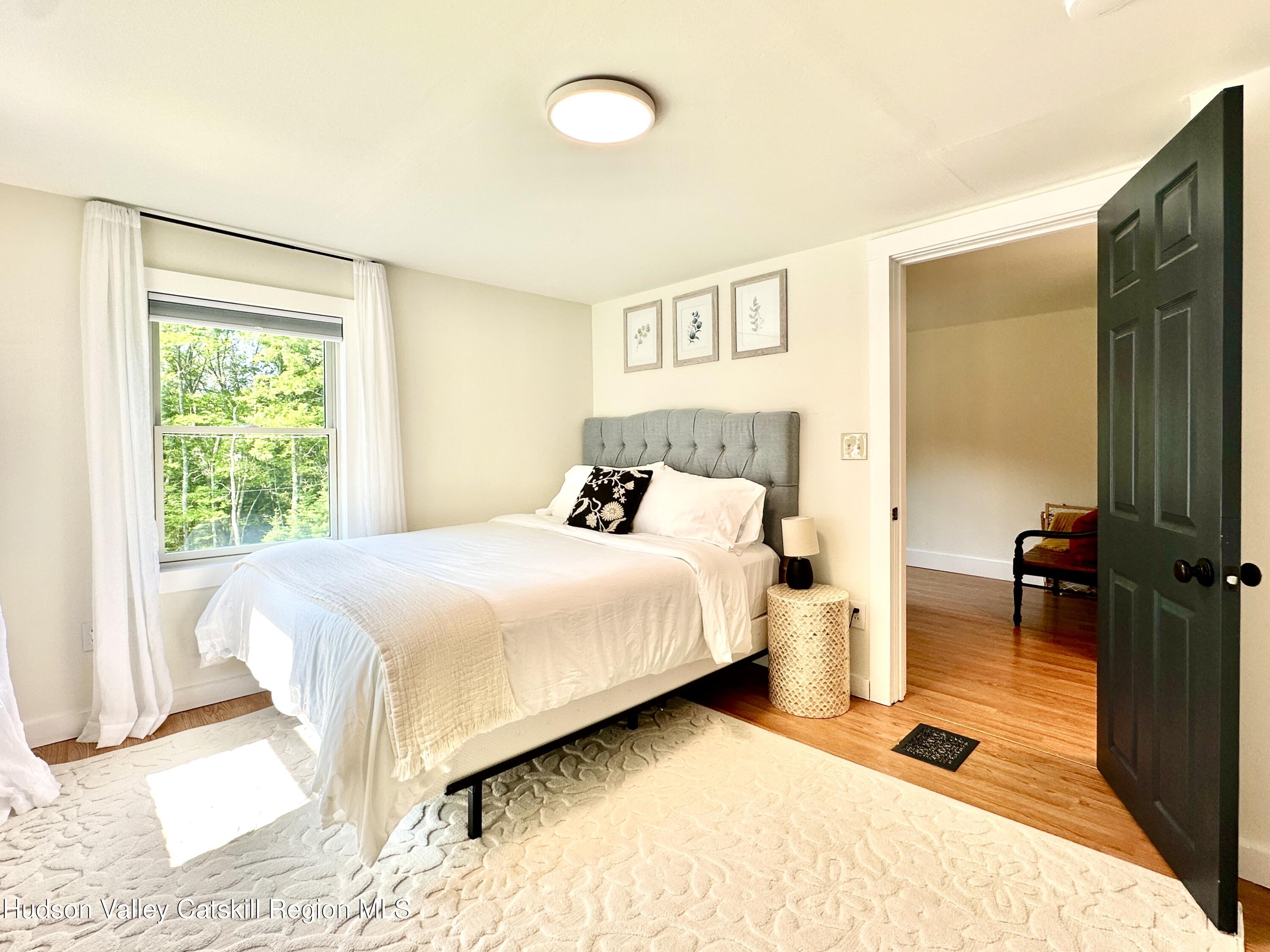 209 Griffin Road East Jewett, NY 12424 - Photo 16 of 34 a bedroom with a bed and wooden floor