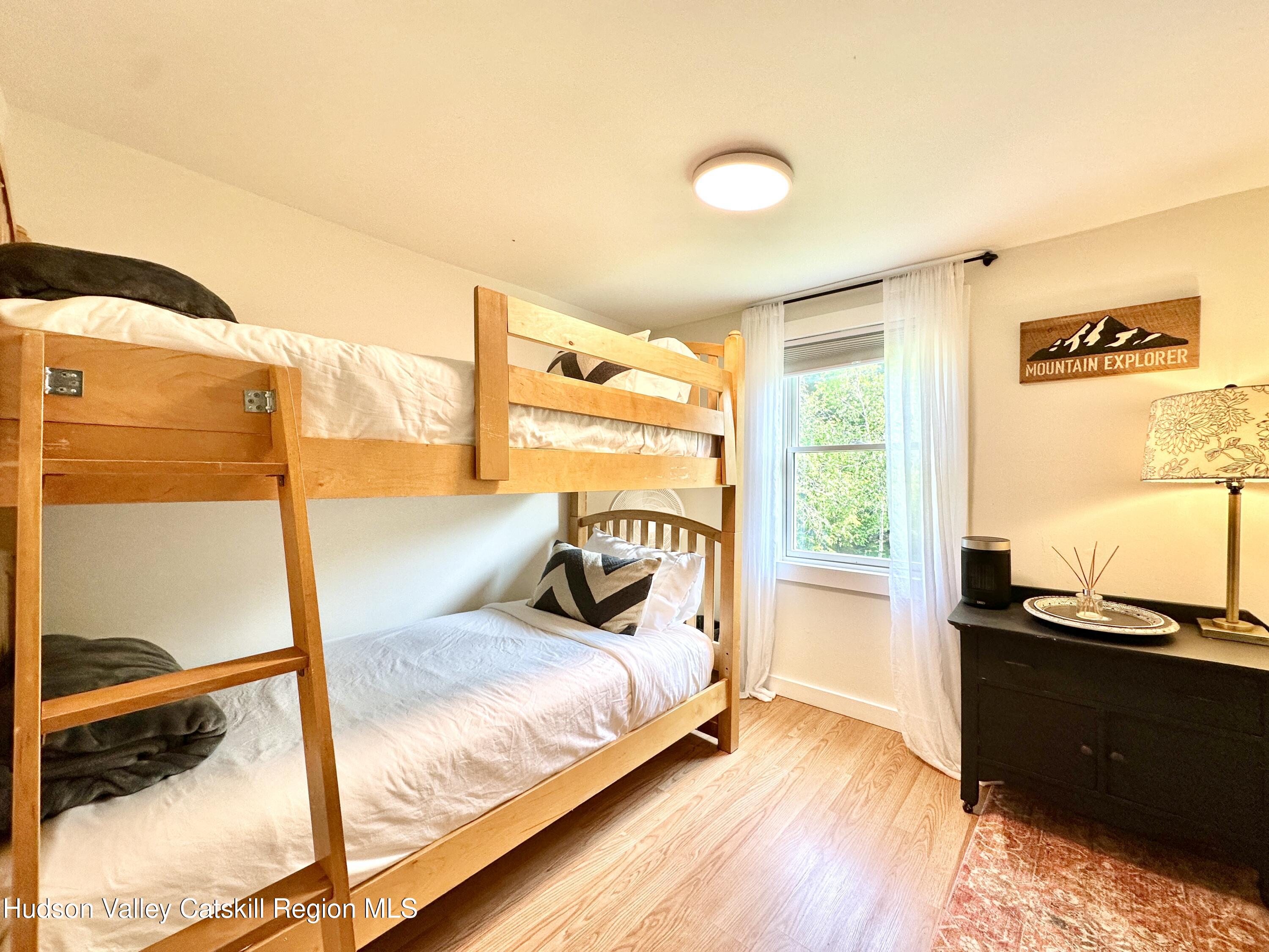 209 Griffin Road East Jewett, NY 12424 - Photo 19 of 34 a bedroom with a bed and a night stand