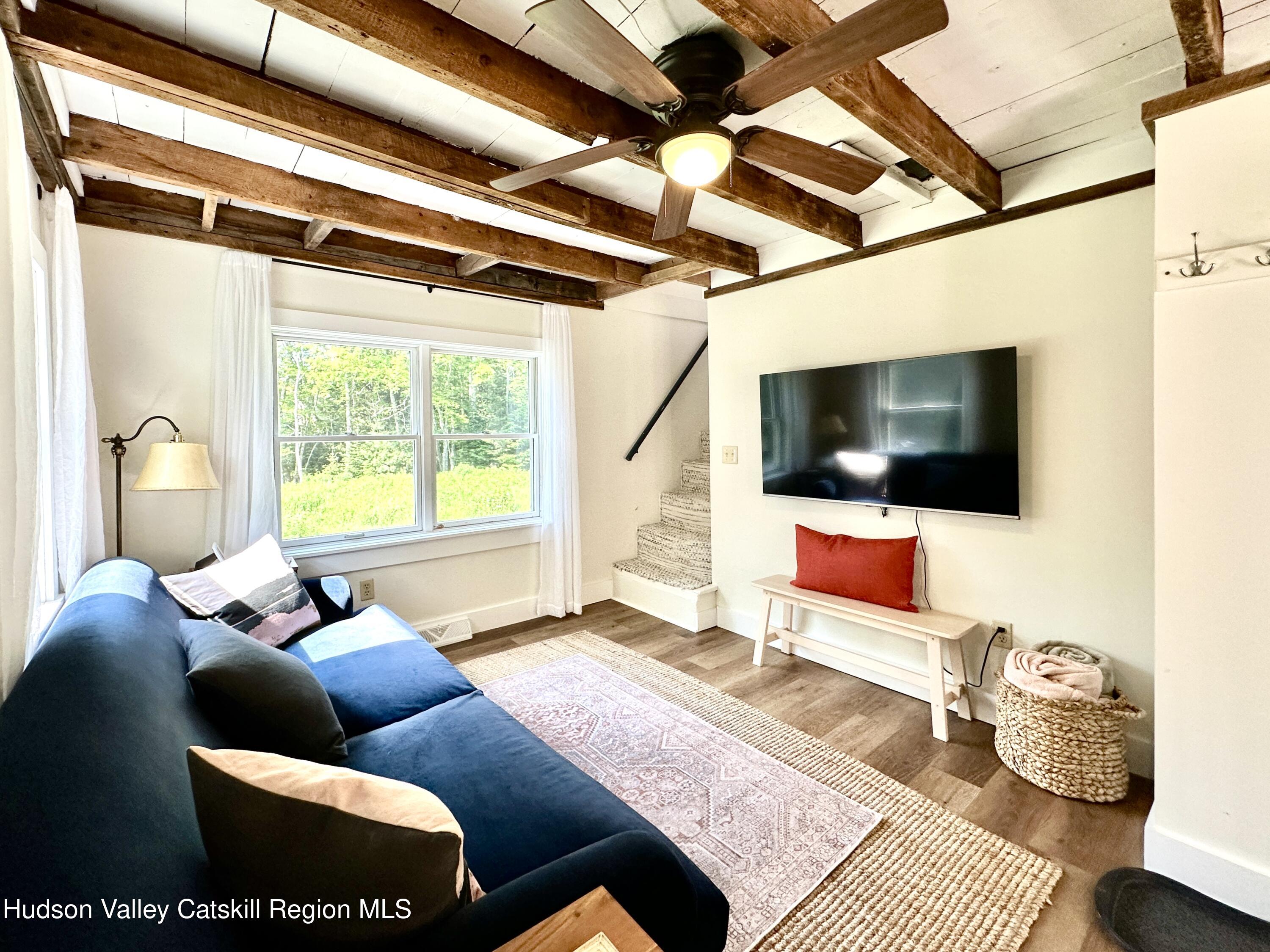 209 Griffin Road East Jewett, NY 12424 - Photo 6 of 34 a living room with furniture and a flat screen tv