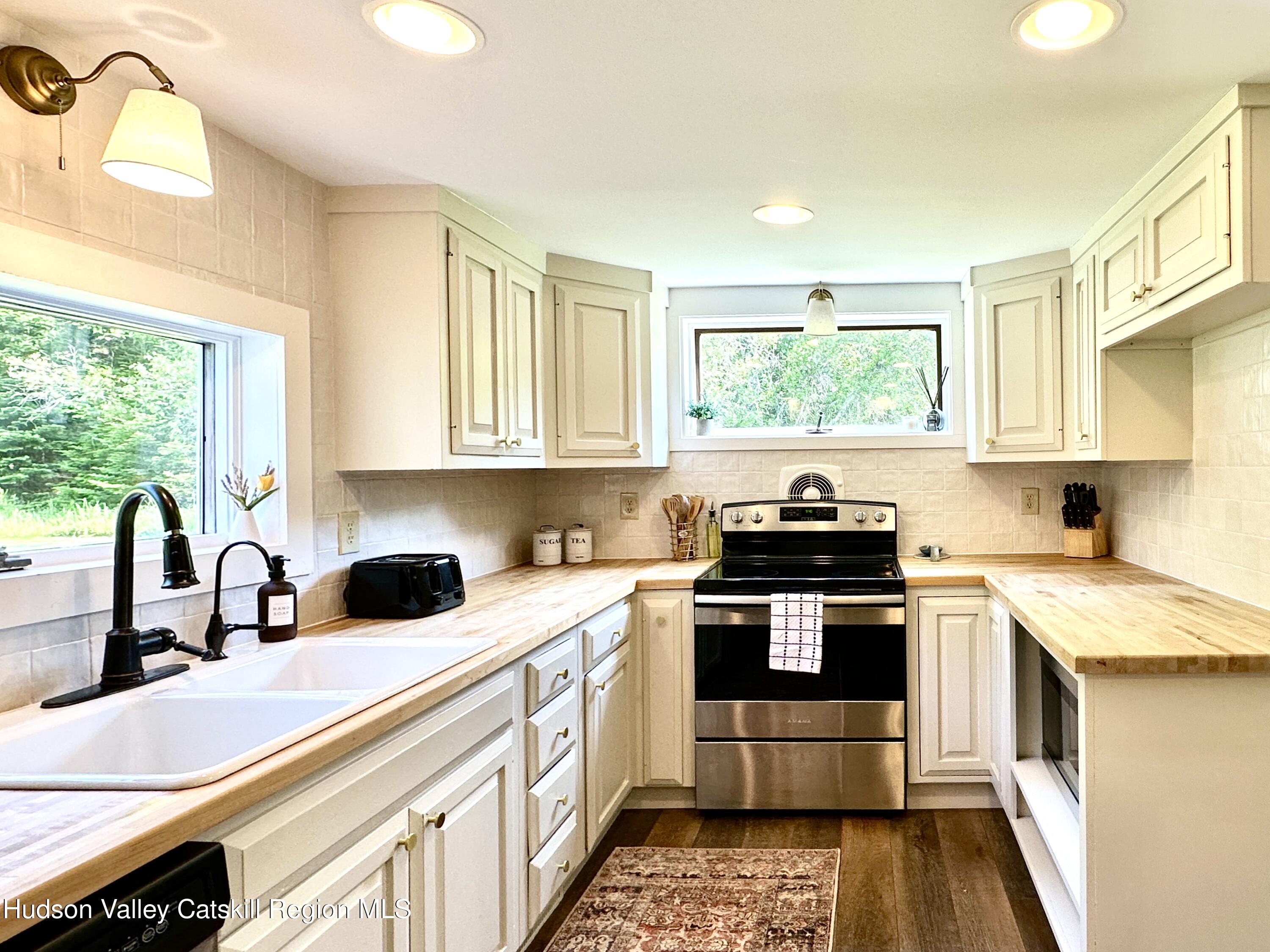 209 Griffin Road East Jewett, NY 12424 - Photo 7 of 34 a kitchen with a sink stove and cabinets