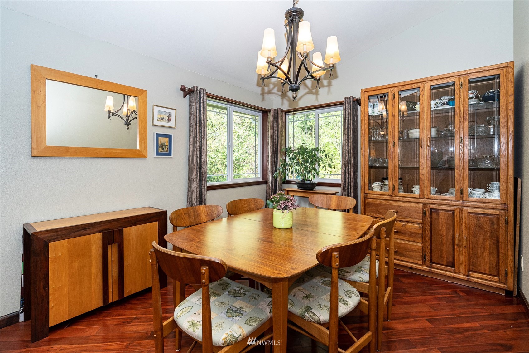 101-04 Hawkins Road Winlock, WA 98596 - Photo 27 of 40 a dining room with furniture a chandelier and wooden floor