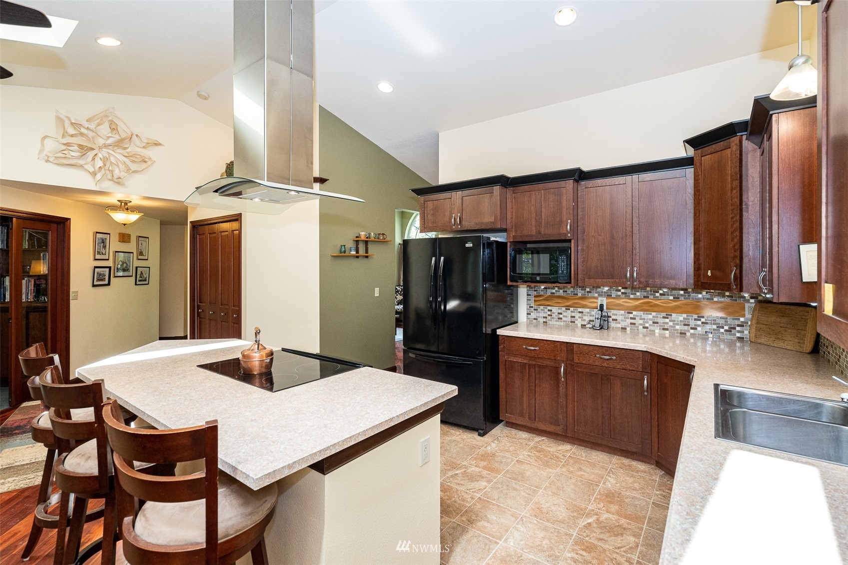 101-04 Hawkins Road Winlock, WA 98596 - Photo 29 of 40 a kitchen with a stove a refrigerator and a dining table
