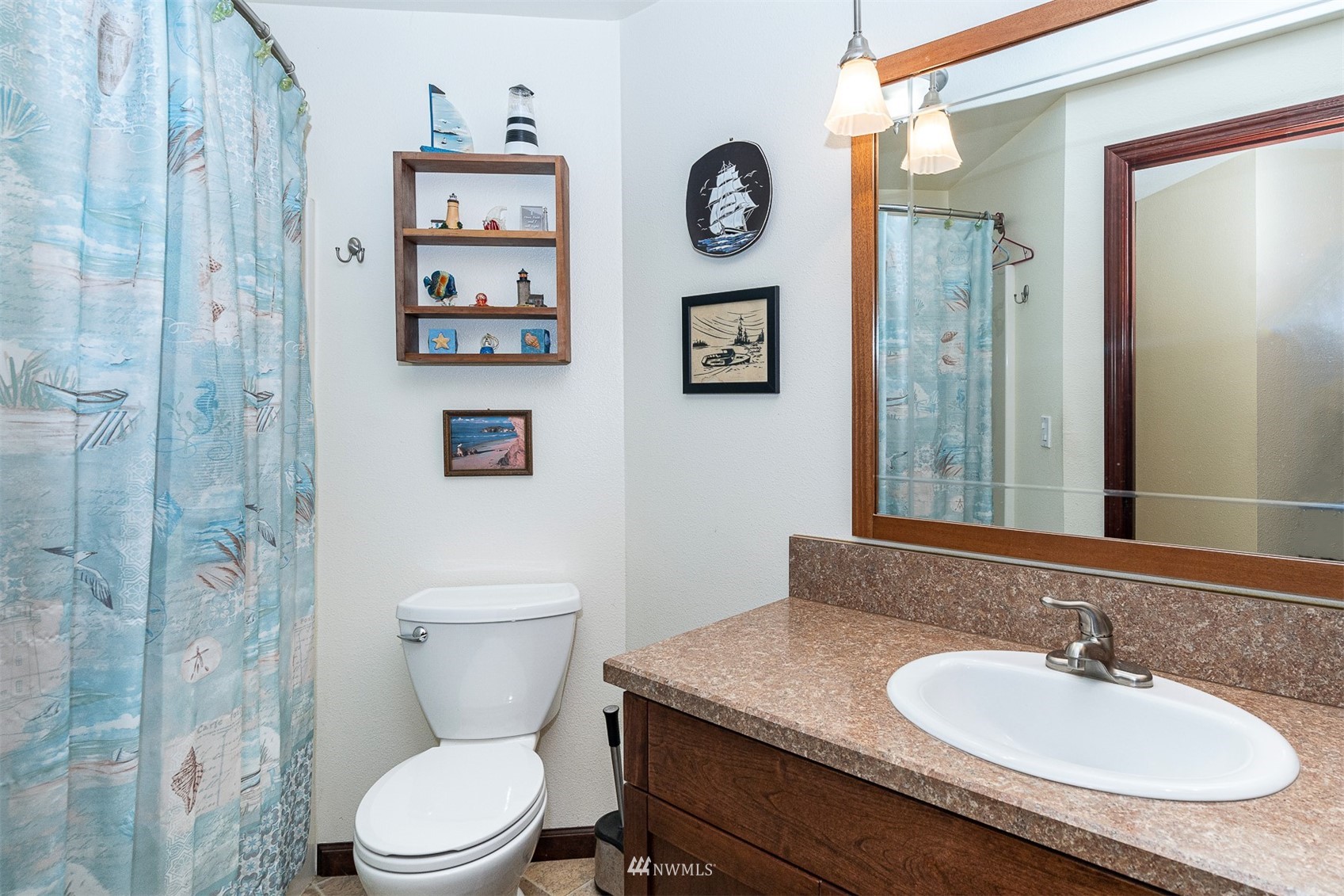 101-04 Hawkins Road Winlock, WA 98596 - Photo 33 of 40 a bathroom with a toilet a sink and a mirror