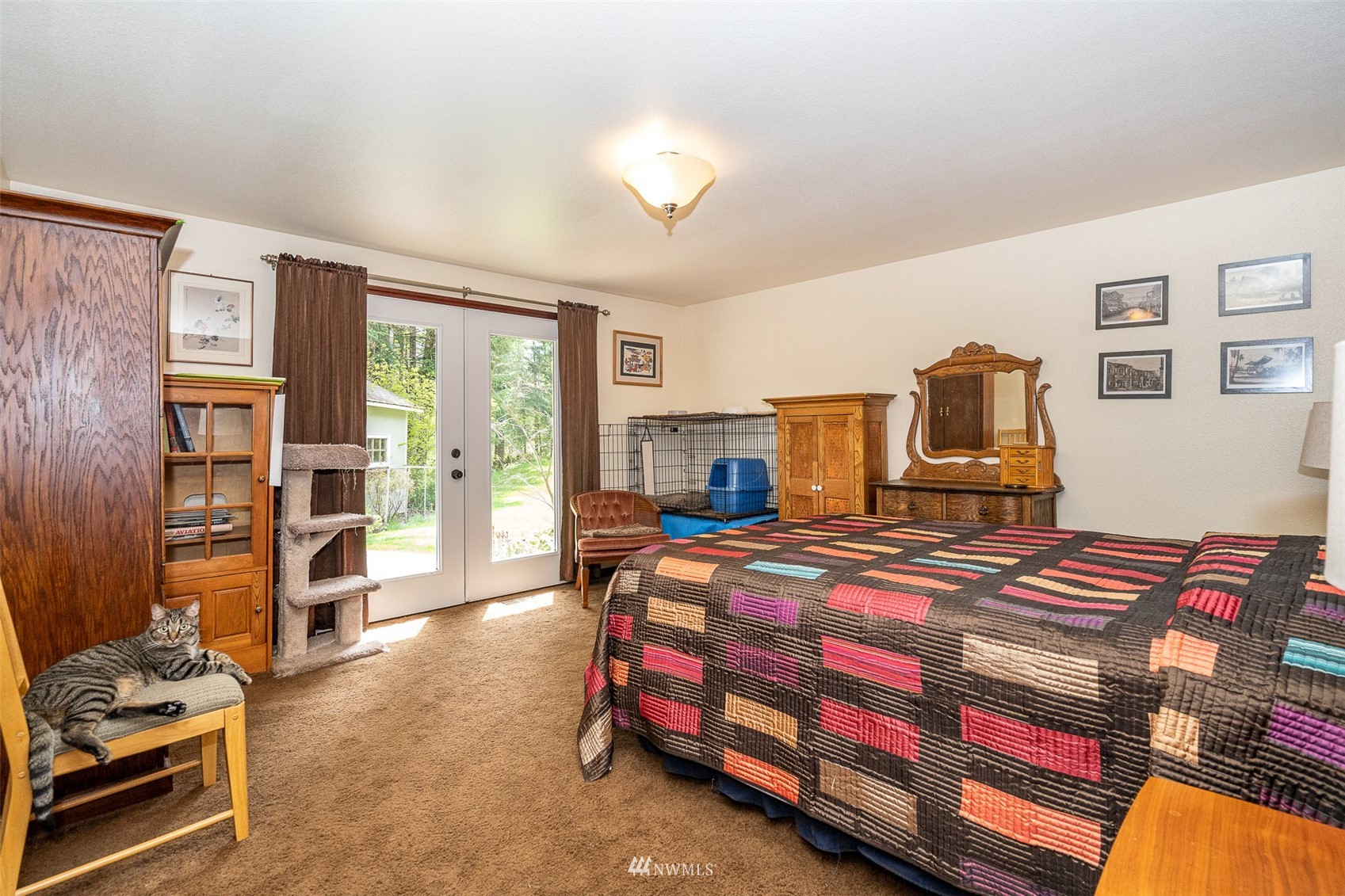 101-04 Hawkins Road Winlock, WA 98596 - Photo 34 of 40 a bedroom with a bed and wooden floor