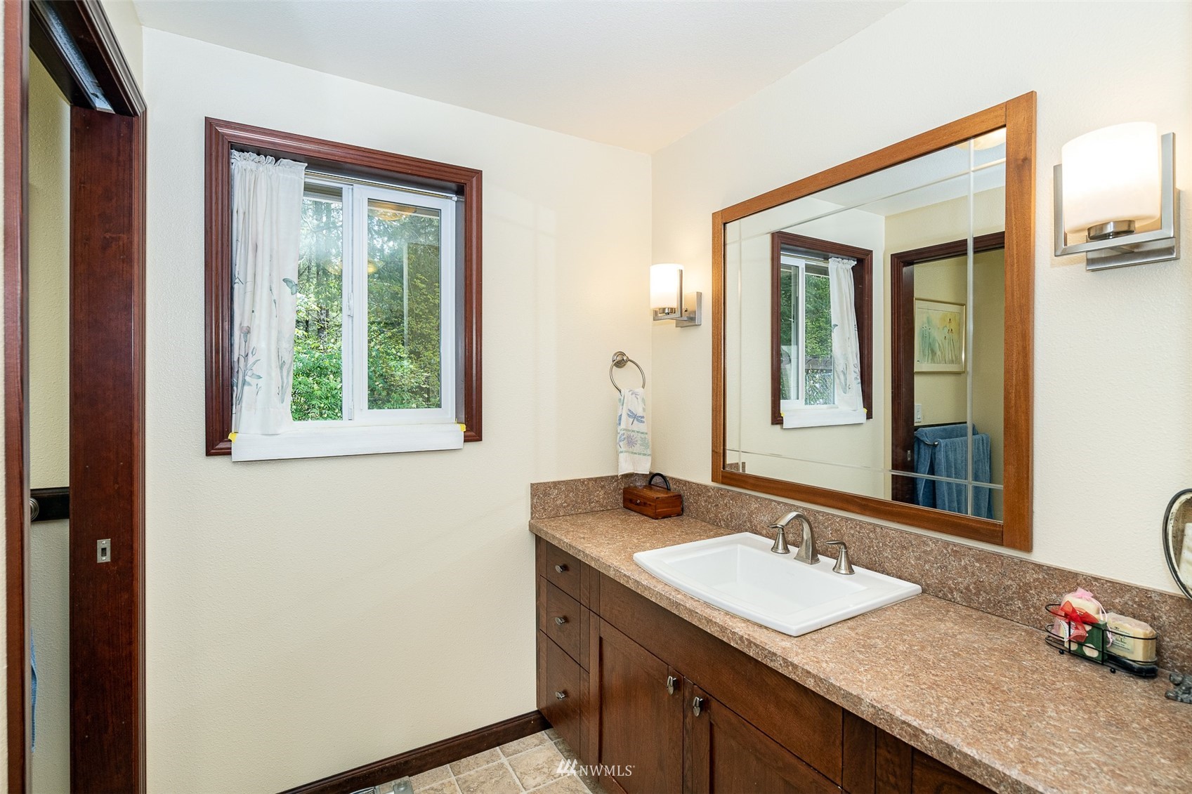101-04 Hawkins Road Winlock, WA 98596 - Photo 37 of 40 a bathroom with a granite countertop sink and a mirror