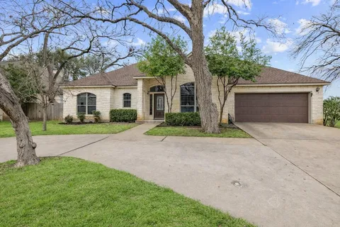 a front view of house with yard and trees