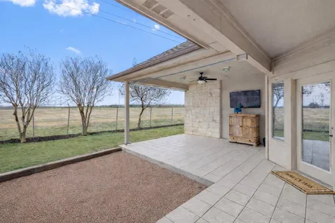 a view of a house with backyard and tree