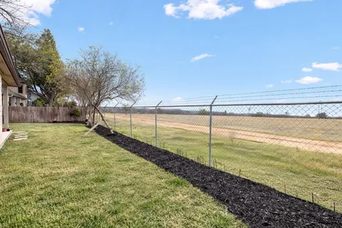 a view of a backyard with swimming pool and an outdoor space
