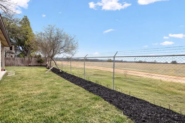 a view of a backyard with swimming pool and an outdoor space