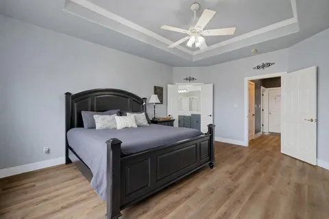 a bedroom with a bed and a ceiling fan