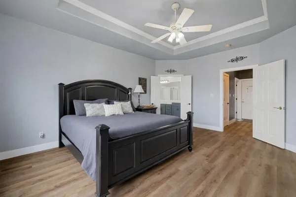 a bedroom with a bed and a ceiling fan
