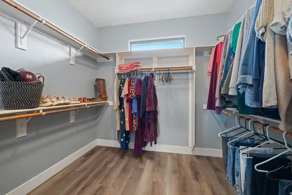 a view of walk in closet with clothes