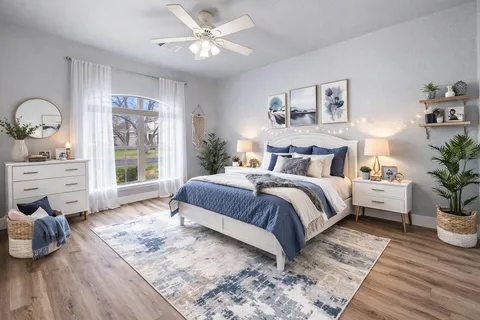 a spacious bedroom with a bed and wooden floor