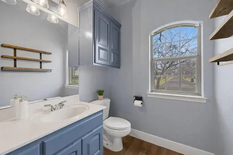 a bathroom with a sink vanity and toilet