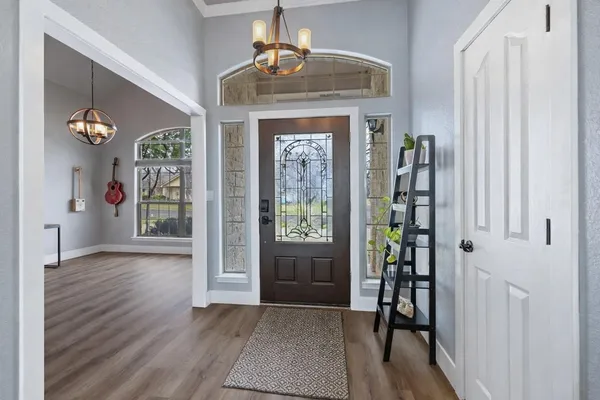 a view of an entryway with wooden floor