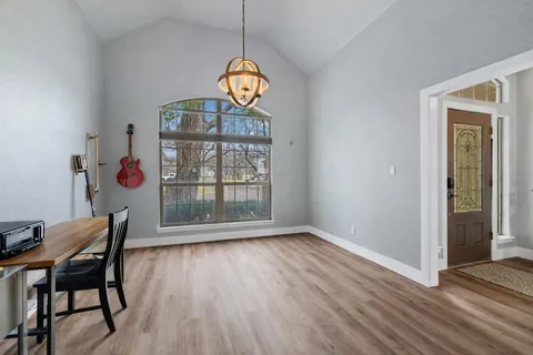 a view of a dining room with furniture wooden floor and chandelier