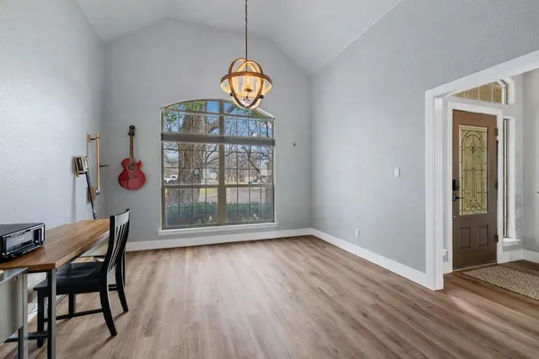 a view of a dining room with furniture wooden floor and chandelier