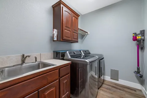 a utility room with sink dryer and washer