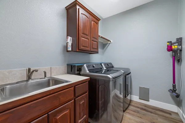 a utility room with sink dryer and washer