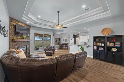 a living room with furniture and a floor to ceiling window