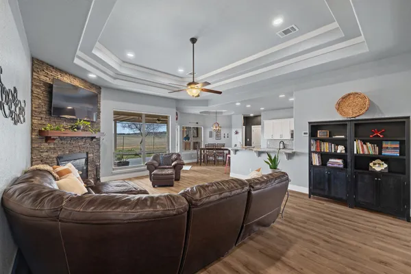 a living room with furniture and a floor to ceiling window