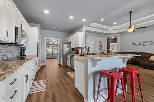 a kitchen with counter top space a sink stainless steel appliances and cabinets