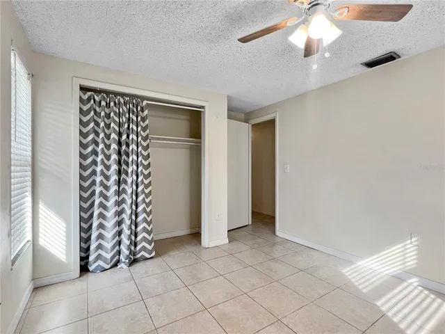 a view of a livingroom with an empty space and a window