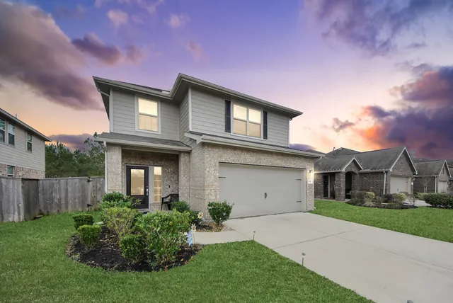 a front view of house with a garden