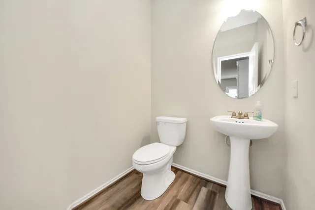 a bathroom with a sink toilet and a mirror